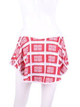 Load image into Gallery viewer, This gorgeous mini heart on white LOVE "O" Skirt has shorties underneath and NO seams on the "O"! It's cut like a doughnut to show and move beautifully as you play. The fabric is uber soft and light - it dries quickly - and protects from UV rays too. This skirt has a “nearly naked” feel about it.