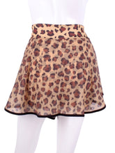 Load image into Gallery viewer, This limited Leopard Mesh LOVE "O" Skirt has shorties underneath and NO seams on the "O"!  It's cut like a doughnut to show and move beautifully as you play.  The fabric is uber soft and light - it dries quickly - and protects from UV rays too.  This skirt has a “nearly naked” feel about it.   Sleek black thread and binding.