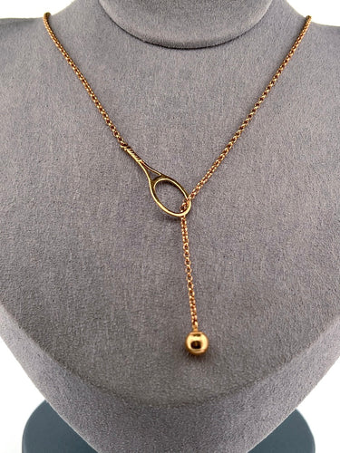 The newest design by Adeline - this unusual necklace is a tennis lovers delight.   The solid gold ball threads through the racket and can be worn higher or lower on the neck.  This piece was hand made in the jewelry district of Los Angeles by a fine jewel craft team.  The racket is 1