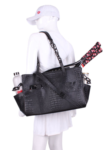 The Long Tennis Tote in Black Vegan Alligator is our stylish, sexy and functional tennis bag designed to carry all your essentials for the game. 
