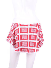 Load image into Gallery viewer, This gorgeous mini heart on white LOVE &quot;O&quot; Skirt has shorties underneath and NO seams on the &quot;O&quot;!  It&#39;s cut like a doughnut to show and move beautifully as you play.  The fabric is uber soft and light - it dries quickly - and protects from UV rays too.  This skirt has a “nearly naked” feel about it.
