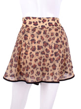 Load image into Gallery viewer, This limited Leopard Mesh LOVE &quot;O&quot; Skirt has shorties underneath and NO seams on the &quot;O&quot;!  It&#39;s cut like a doughnut to show and move beautifully as you play.  The fabric is uber soft and light - it dries quickly - and protects from UV rays too.  This skirt has a “nearly naked” feel about it.   Sleek black thread and binding.
